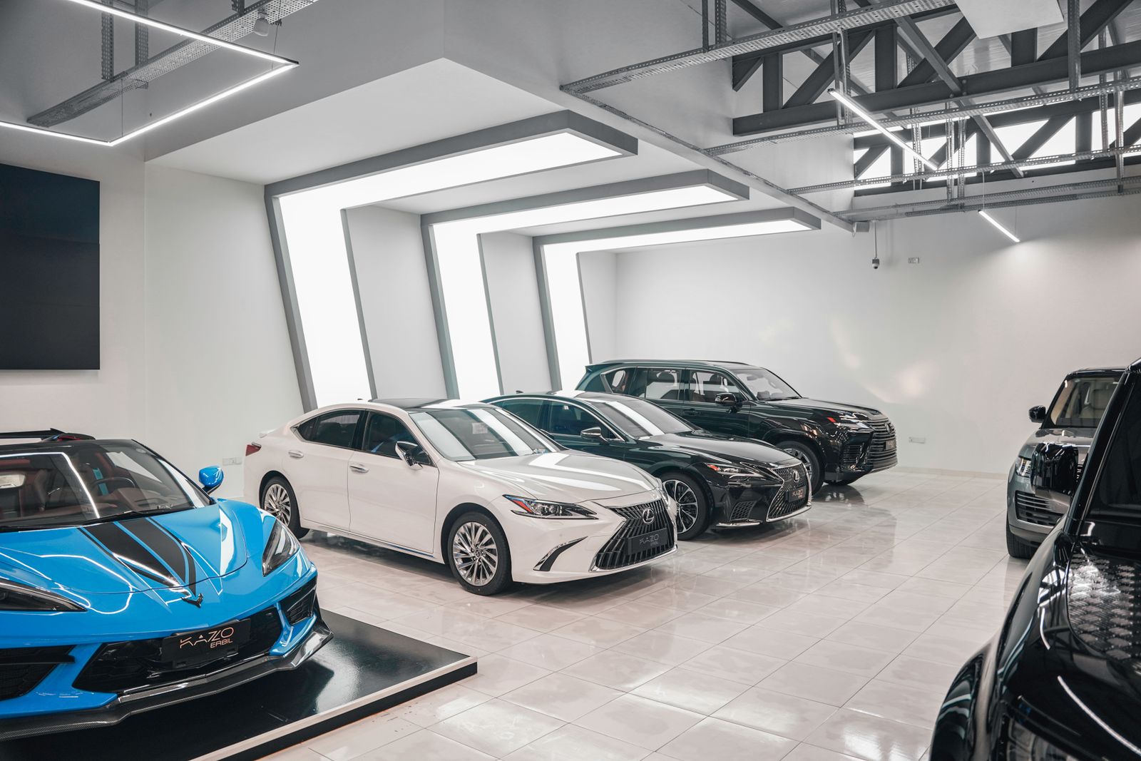 Freshly detailed cars lined up in a dealership showroom