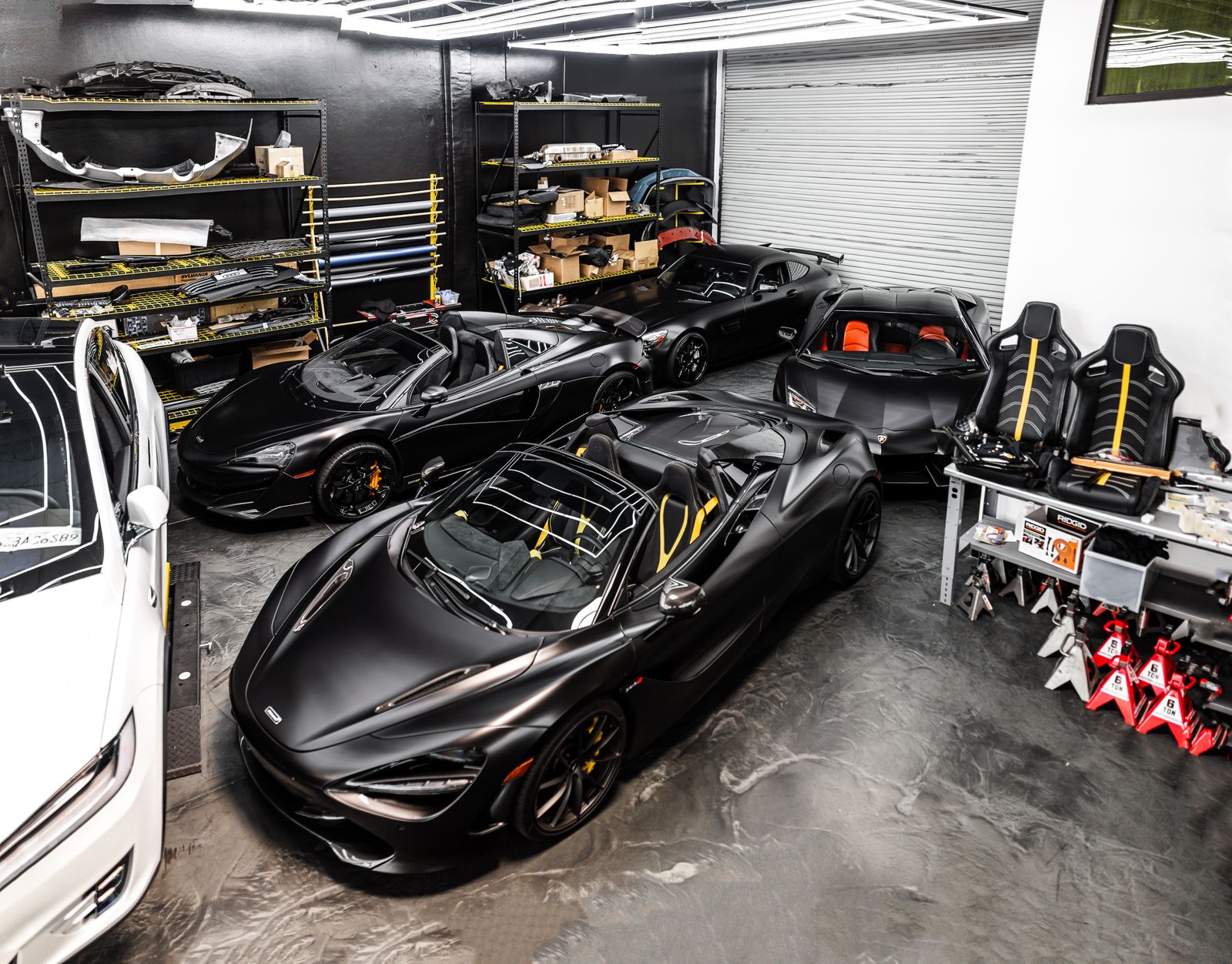 Three sports cars prepped for sale in a garage